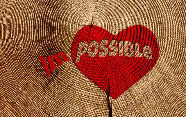 Images shows a heart with the word im- POSSIBLE